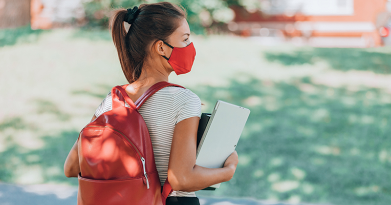 female student wearing mask on campus