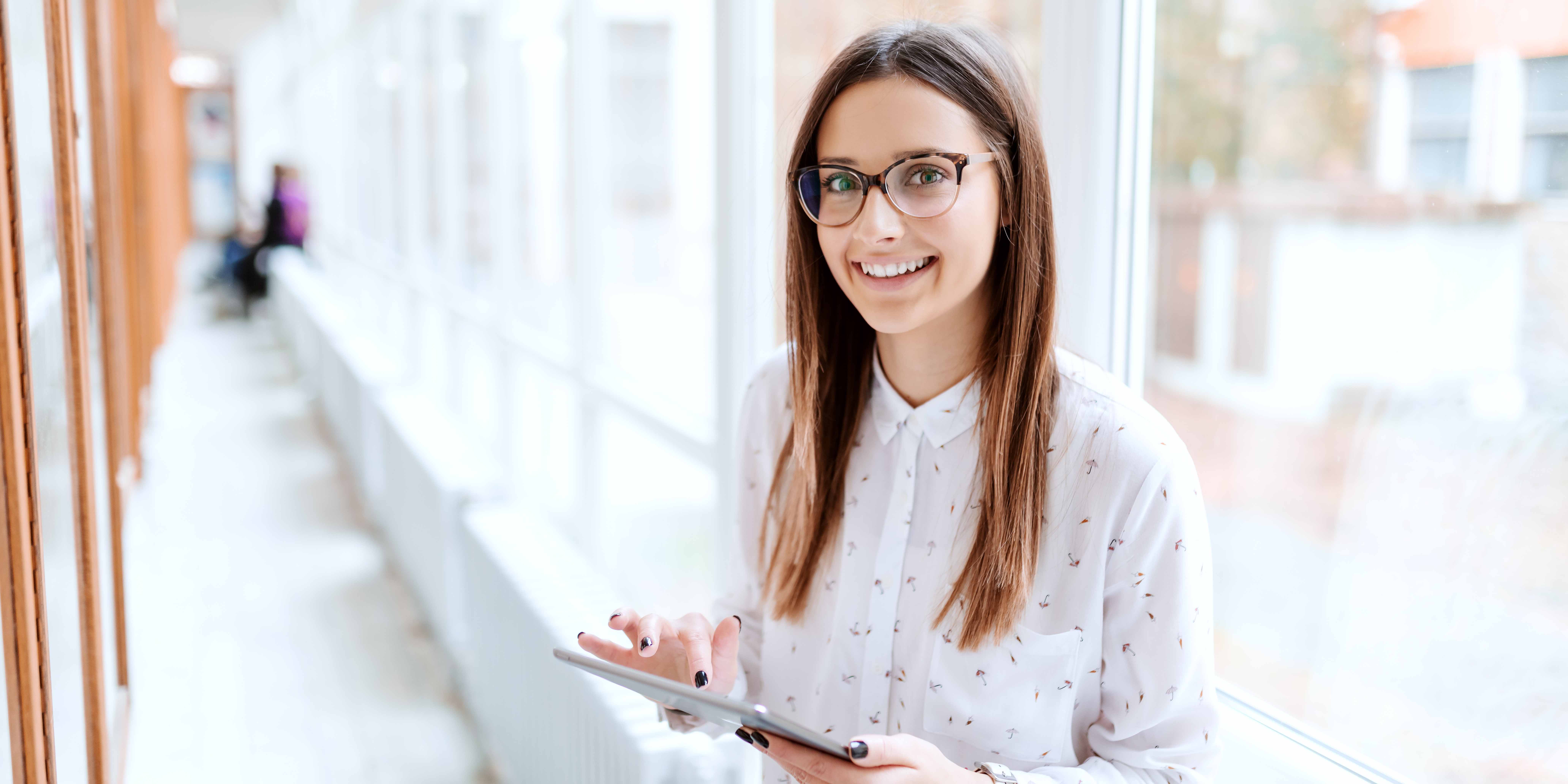 College student standing in office hallway at her summer job