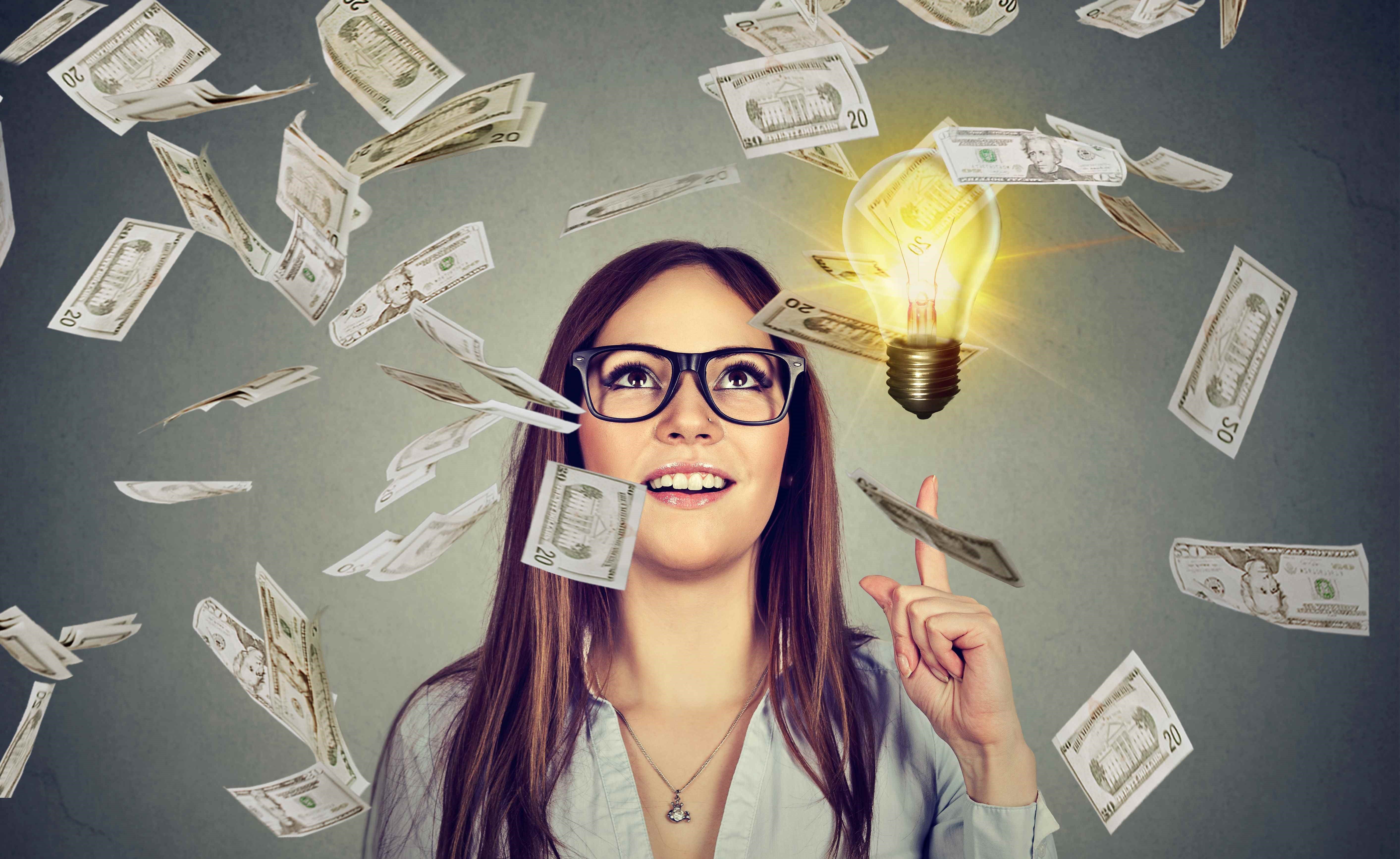 college student looking up as dollar bills rain down
